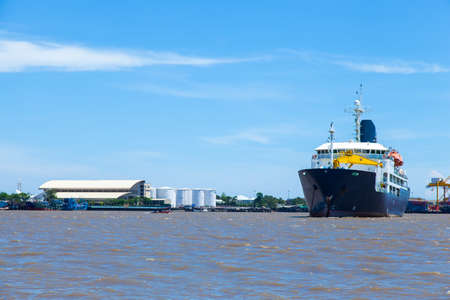 large cargo ship. Moored in the river. Large industrial port with freight.の写真素材