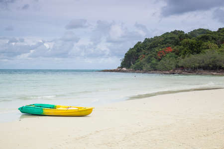 Boat moored on the beach sand. Have washed up on the beach. Behind the island.の写真素材