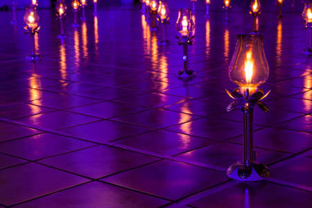 Lamps were lit and placed on the ground. A row in the temple. To religious blessings.の写真素材