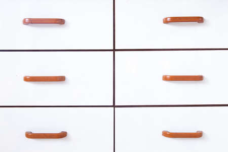 Drawers with wooden handles. Drawer and drawer handles are made of white wood.の写真素材
