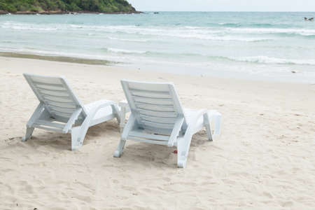 White bench and table on a beach by the sea. A relaxing holiday.の写真素材