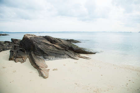 Large rocks. On the beach by the sea. A storm is coming.