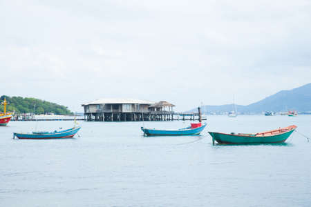 Small fishing boat. Moored at sea. Behind the resort.の写真素材