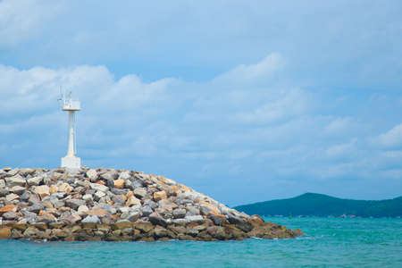 Coastal areas lighthouse. On coastal rocks to roll out into the sea.の写真素材
