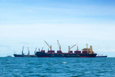 large cargo ship. Moored offshore. The import and export of goods waiting.