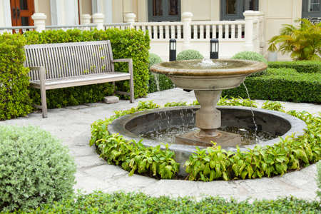 Basin and bench Placed in the garden area of ââthe park is decorated with trees.の写真素材