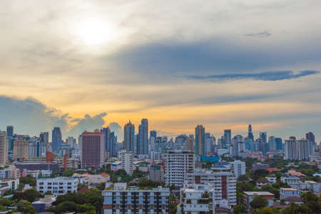 Bangkok city has a number of high buildings. Condo for accommodation and offices. Sky in the evening with the sun.のeditorial素材