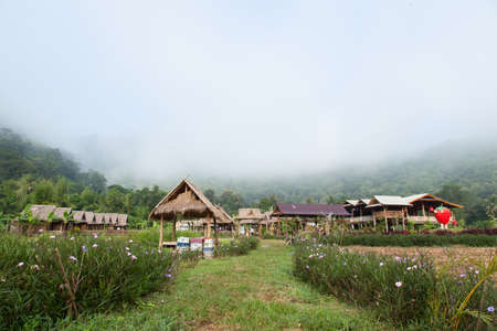 hut in the fields Wooden cottage on the grounds. The mist-shrouded mountains in background.のeditorial素材