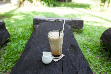 cup of coffee syrup, place the side. On a piece of wood in the garden