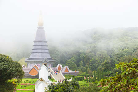 Pagoda in the fog mountains and trees in the mountains are concentrated.の写真素材