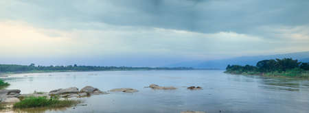 panorama forest and mountain.Near the dark sky and cloud cover.の写真素材