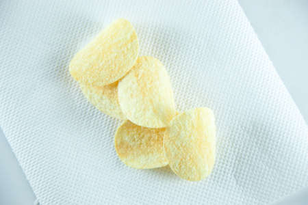 potato chips on tissue in white isolated.white background studio packshot.