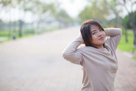 Portrait Asian woman in a park. Relax and have fun in the park.の写真素材