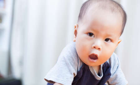 Baby boy.child Asian., And played on the orange sofa.の写真素材