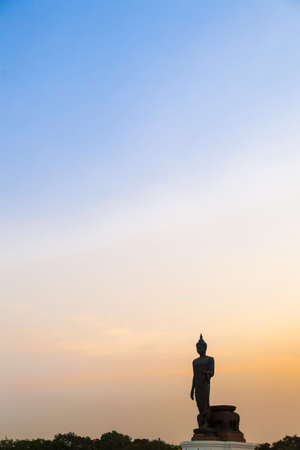 Big Buddha in the evening. The dark sky with bright sunshine in the evening.の写真素材