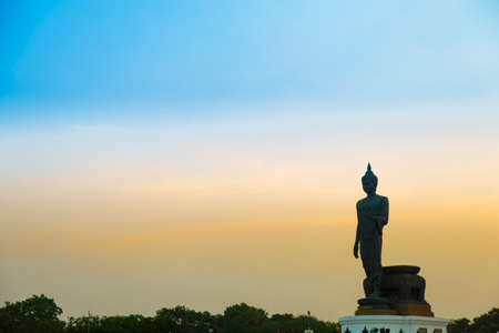 Big Buddha in the evening. The dark sky with bright sunshine in the evening.の写真素材