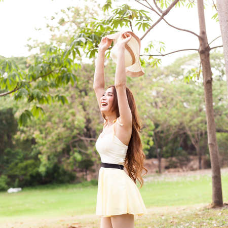 Woman relaxing in the park. On the lawn with shady trees.の写真素材