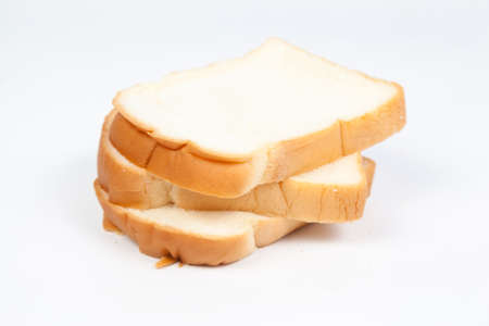Sliced ââbread on a white background. Bread stacked in rows.の写真素材