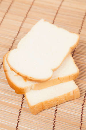 Sliced â€‹â€‹bread on the wooden plate.pack-shot bread in studio.