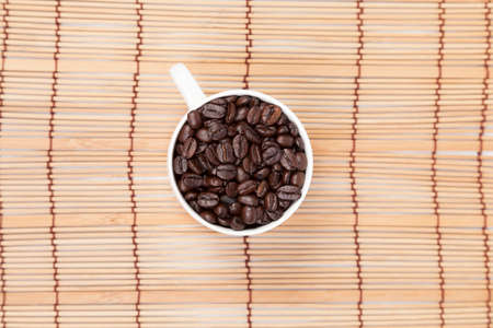 Glass of white coffee beans On a wooden table top