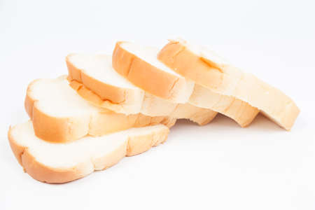 Sliced â€‹â€‹bread on a white background. Bread stacked in rows.
