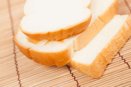 Sliced â€‹â€‹bread on the wooden plate.pack-shot bread in studio.