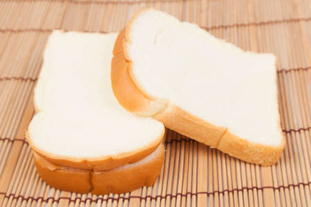 Sliced â€‹â€‹bread on the wooden plate.pack-shot bread in studio.