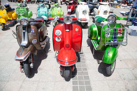 Vespa motorcycles Variety of colors parked at a parking area.のeditorial素材