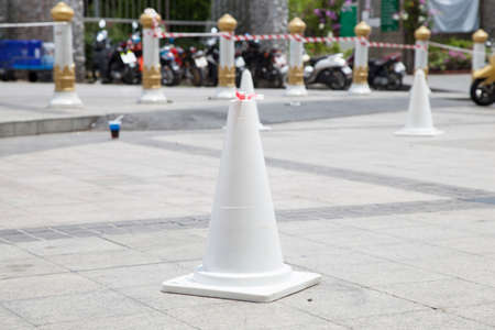 White traffic cone Located on ground to tell the parking area.の写真素材