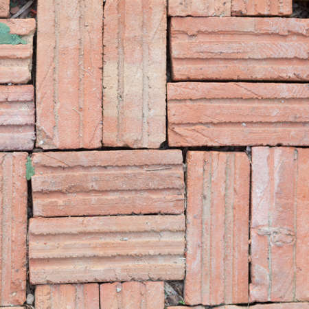 Brown brick tiles. The walls of the building. The scene with cement.