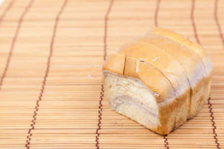 Sliced bread placed on wood. Bread is cut into pieces evenly.
