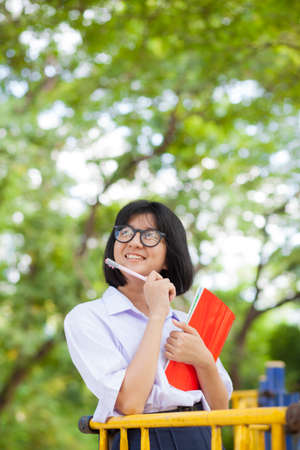 Schoolgirl Red letters Smiling and happy and relaxed. In the park