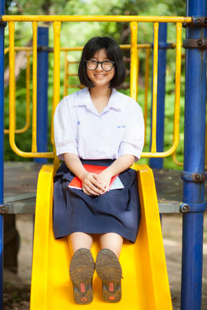 Portrait schoolgirl smiling a happy. At the playground in the park.の写真素材