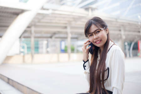 Businesswoman talking phone. Happy while talking on the phone.の写真素材