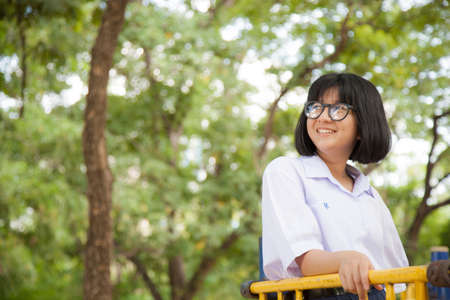 Portrait of Asian schoolgirl Smiling a happy in the park.
