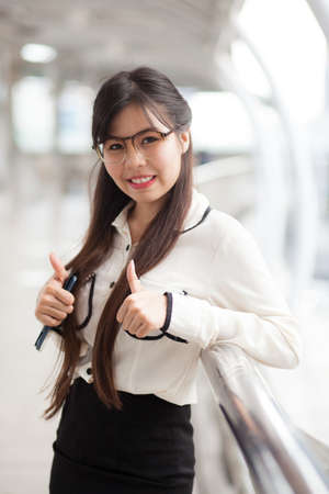 Happy businesswoman standing on sidewalk.smile and relax businesswoman.の写真素材