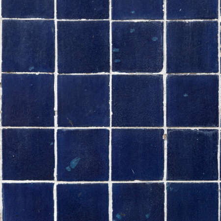 Blue square tiles. Formation on the wall.water and dirt stain.の写真素材