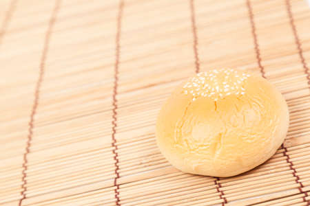 Bread sphere. A small white beans on top of bread. Placed on woodの写真素材