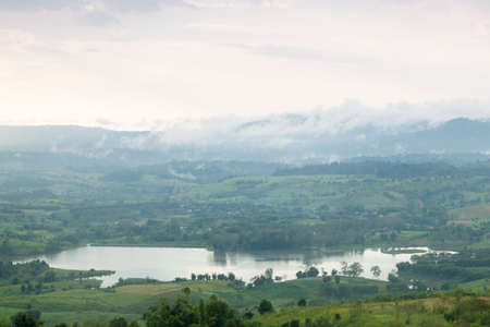 Mist covered mountains and farmland.の写真素材