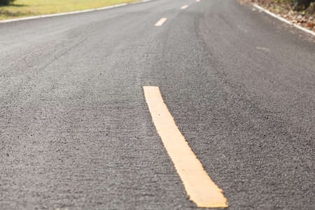 The yellow curve on the road. の写真素材