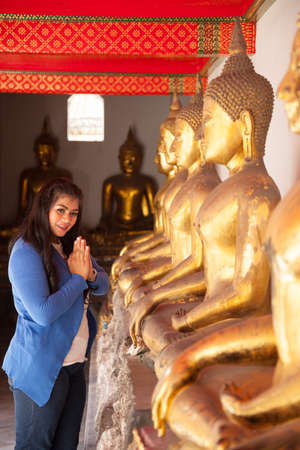 Woman worshiping Buddha in temple. Buddha in a temple tourism in Thailand.