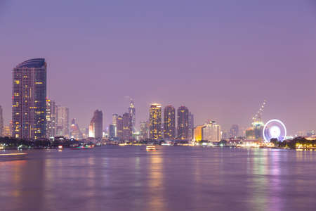 Bangkok city at night. Building a skyscraper lit A river through the cityの写真素材