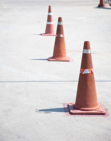 Putting together a line of traffic cones on the road to car traffic.の写真素材