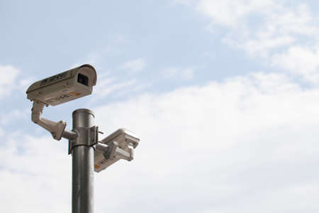 CCTV cameras on poles. Behind the clear sky in the daytime.の写真素材