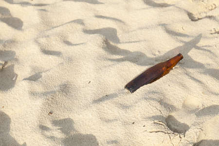 Bottle on the beach. The bottle was left on the beach. Pollution of waste that was destroyed by tourists.の写真素材