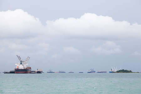 Cargo ship. Parking in the sea to await transportation to the port.の写真素材