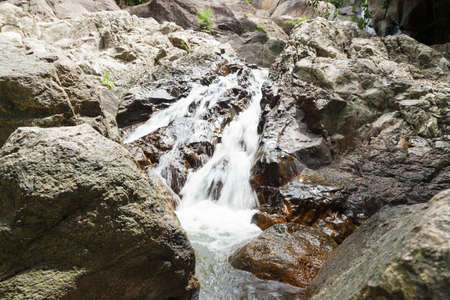 Water falling from a cliff. Water flowing down from the rocks of the waterfall. On Koh Samuiの写真素材