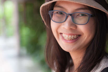 clouse up face asia woman.joy and smile woman wear hat and eyeglasses.の写真素材