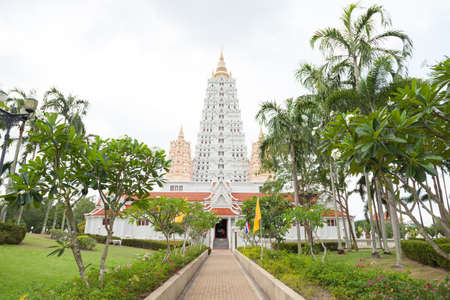 Big White Pagoda Temple, Thailand. There is an entrance lined with trees and gardens.の写真素材