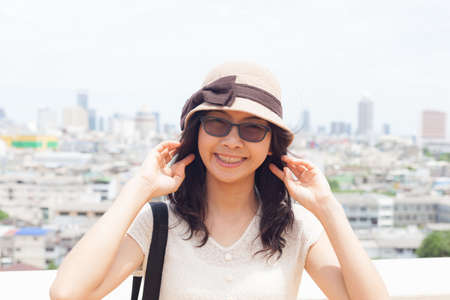 joy and smile asia woman.wear eyeglasses and hat.smile and relax.の写真素材